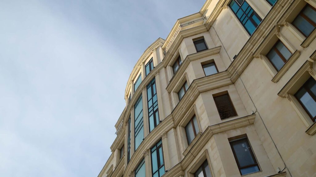 Building exterior with stucco facade and arched architectural details